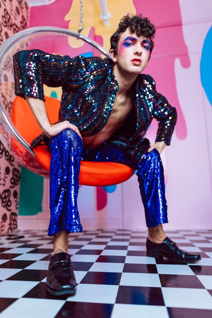 Dynamic portrait featuring a model in colorful sequin attire in a vibrant setting.